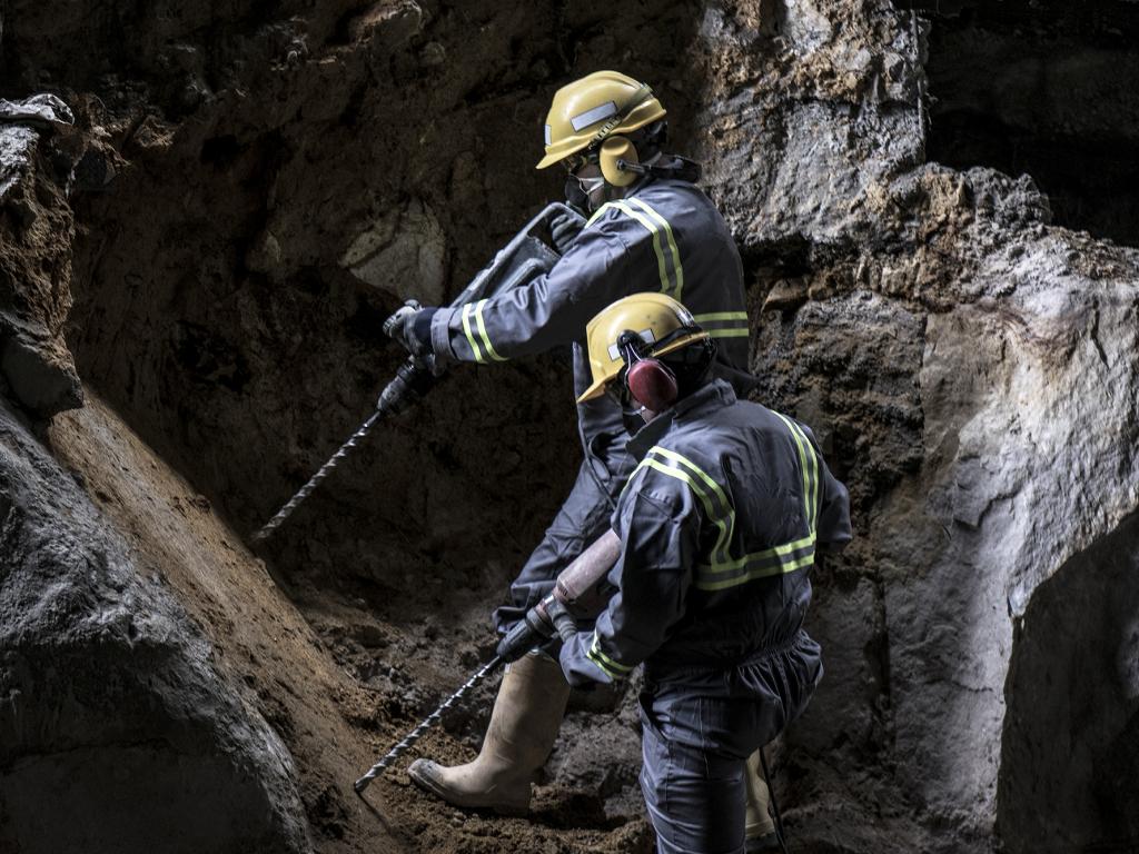 MIH crew in full PPE drilling a face during underground production work